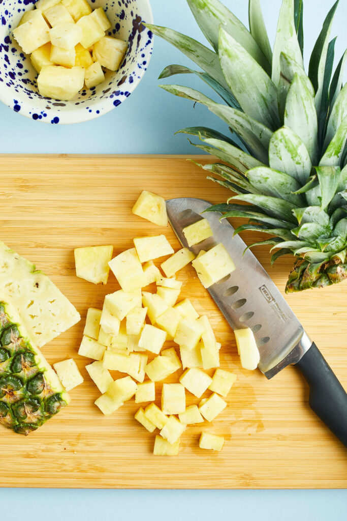 a cutting board with chopped pineapple